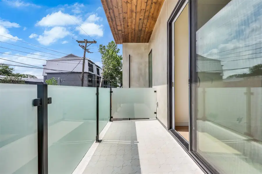 A private outdoor nook off the bedroom, finished with powder-coated railings for that sharp, architectural edge