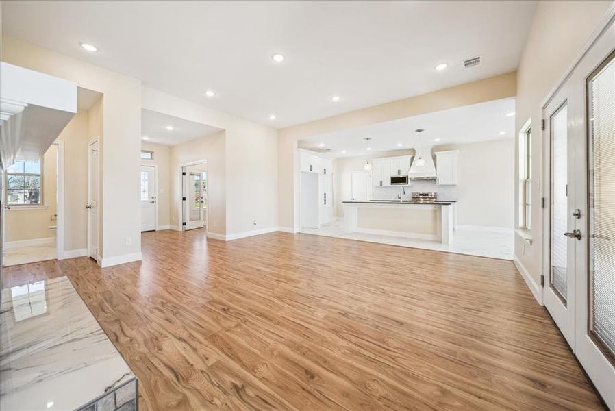 Unfurnished living room with light hardwood / wood-style floors