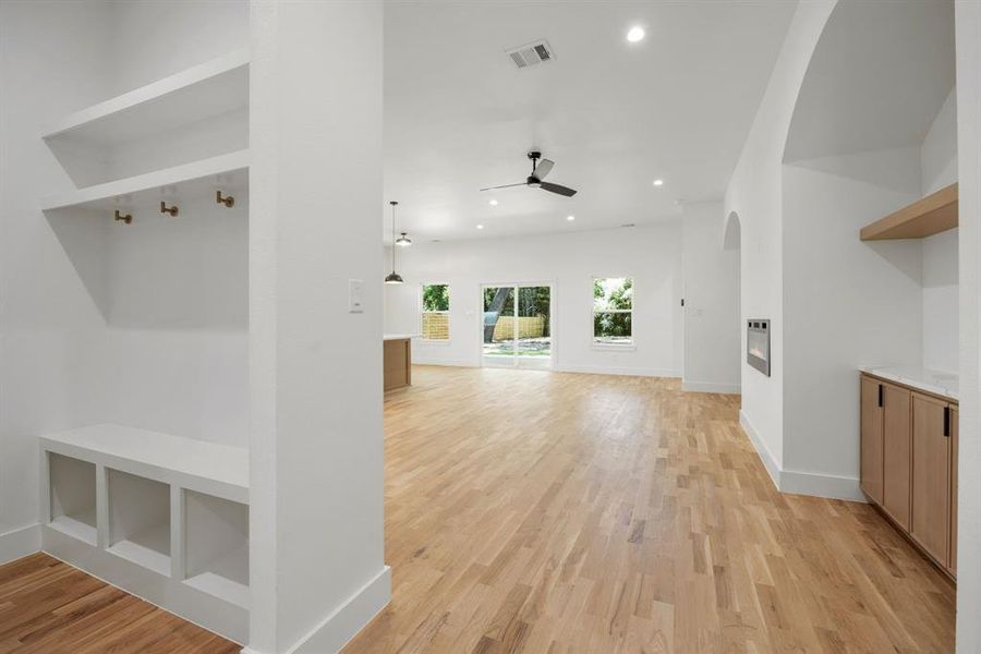 Just inside the entrance from the attached two-car garage, a thoughtfully designed mudroom provides the perfect drop zone for coats, umbrellas, backpacks, and other everyday essentials, helping keep the home organized and clutter-free. Just inside the entrance from the attached two-car garage, a thoughtfully designed mudroom provides the perfect drop zone for coats, umbrellas, backpacks, and other everyday essentials, helping keep the home organized and clutter-free.