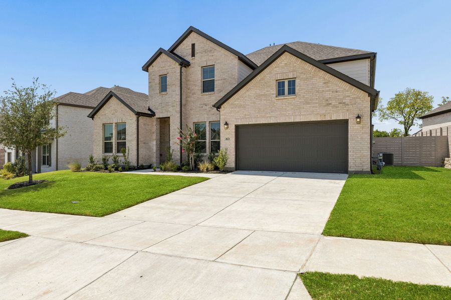 Front exterior of a new home in Painted Tree Lakeside, McKinney, TX, highlighting curb appeal (Image 2). Front exterior of a new home in Painted Tree Lakeside, McKinney, TX, highlighting curb appeal (Image 2).