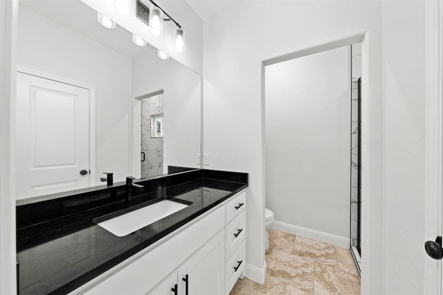 Bathroom with vanity and a stall shower Bathroom with vanity and a stall shower