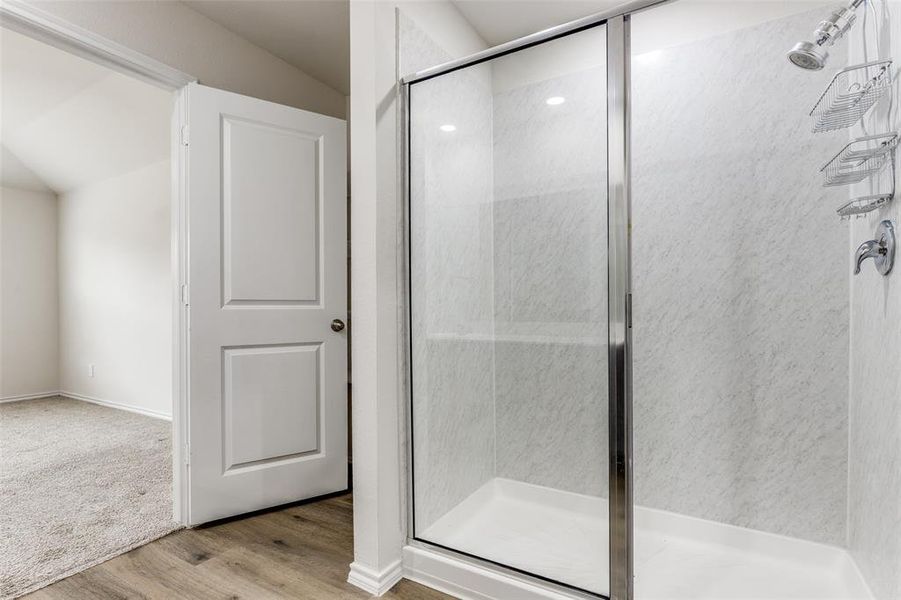 Walk-in shower with clear glass enclosure and white surround Walk-in shower with clear glass enclosure and white surround