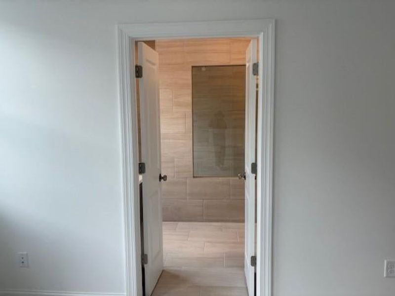 primary bathroom has double doors leading into the bathroom primary bathroom has double doors leading into the bathroom