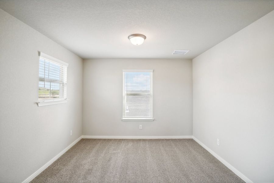 Guest bedroom of the Reynolds floorplan at a Meritage Homes community.