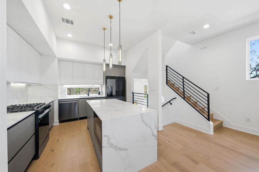 This elegant kitchen features sophisticated European-style cabinets with soft close drawers sleek, minimalist lines paired with stunning quartz countertops for a modern luxury and timeless appeal. This elegant kitchen features sophisticated European-style cabinets with soft close drawers sleek, minimalist lines paired with stunning quartz countertops for a modern luxury and timeless appeal.