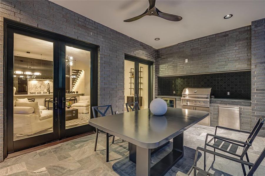 View of patio with french doors, area for grilling, and ceiling fan