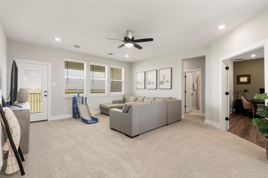 Well-lit and versatile, this living area connects seamlessly to an adjacent home office. Well-lit and versatile, this living area connects seamlessly to an adjacent home office.