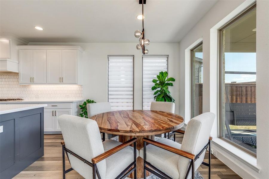 Dining area with recessed lighting and light wood finished floors