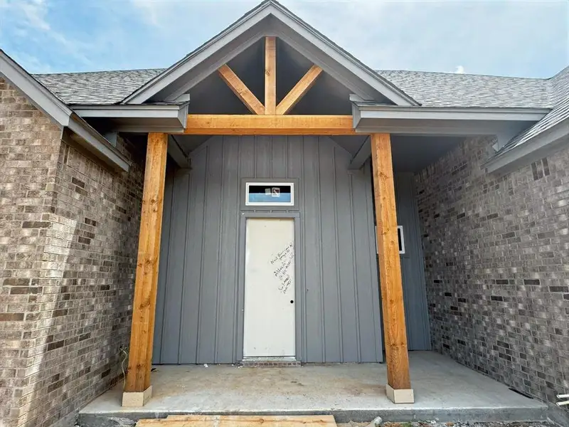 Entrance to property with a shingled roof Entrance to property with a shingled roof