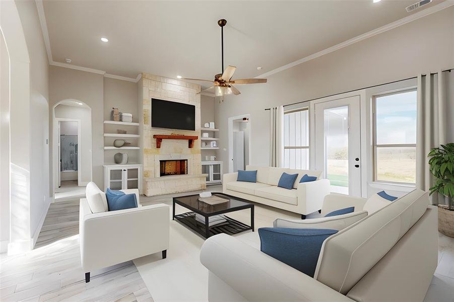 Living room featuring a stone fireplace, built in features, ceiling fan, crown molding, and light hardwood / wood-style flooring