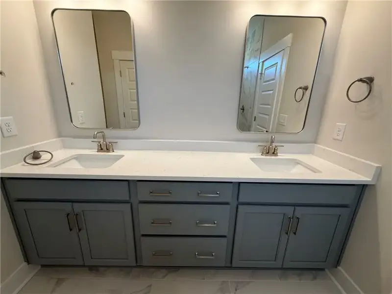 Clean lines and a spacious dual vanity define this