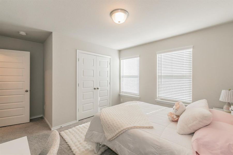 Bedroom featuring carpet floors and a closet