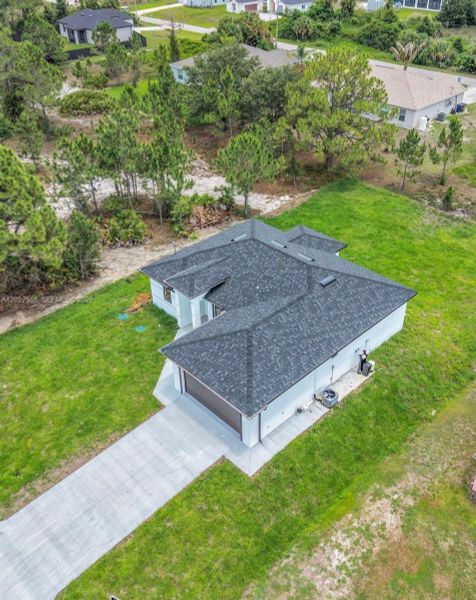 Front exterior of a new home in , Lehigh Acres, FL, highlighting curb appeal (Image 25).