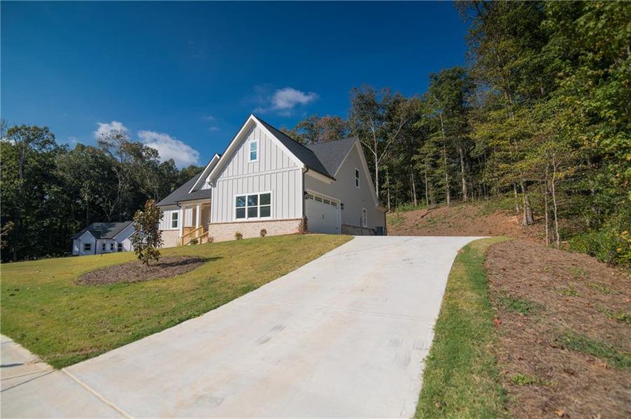 Front exterior of a new home in , Clermont, GA, highlighting curb appeal (Image 26).