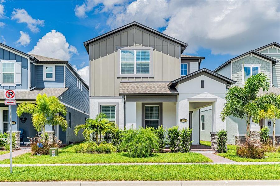 Front exterior of a new home in Encore at Ovation, Winter Garden, FL, highlighting curb appeal (Image 17).