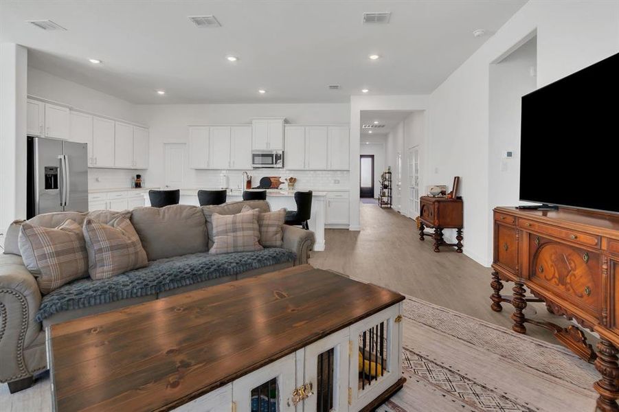 Living room featuring recessed lighting and light wood-type flooring