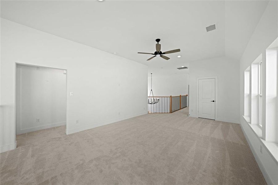Unfurnished living room with light colored carpet and recessed lighting Unfurnished living room with light colored carpet and recessed lighting
