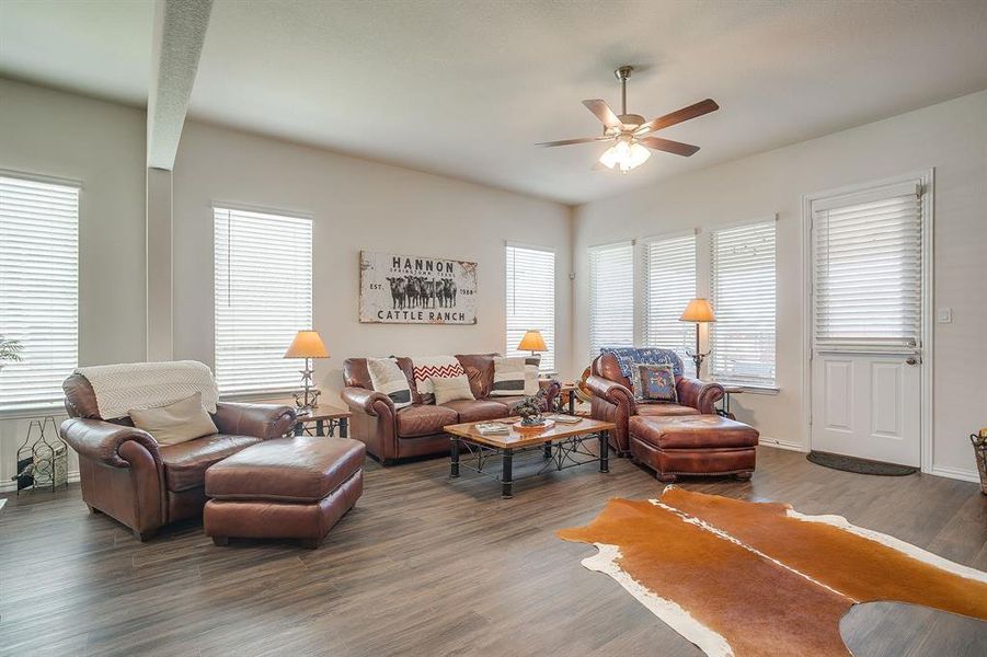 Living room featuring wood finished floors and a ceiling fan Living room featuring wood finished floors and a ceiling fan
