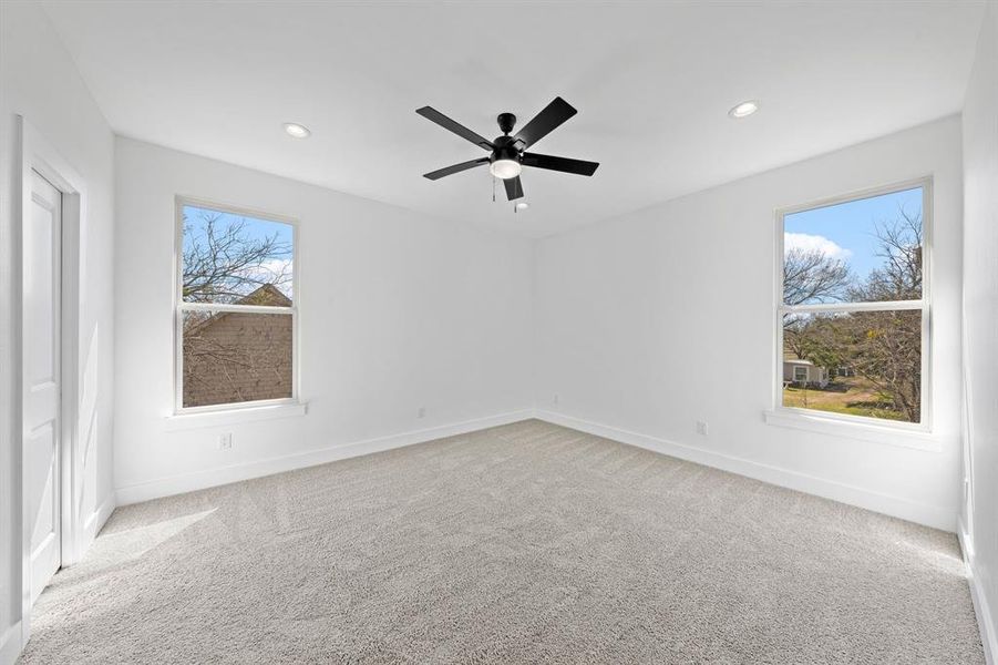 Unfurnished room featuring recessed lighting, light carpet, and baseboards