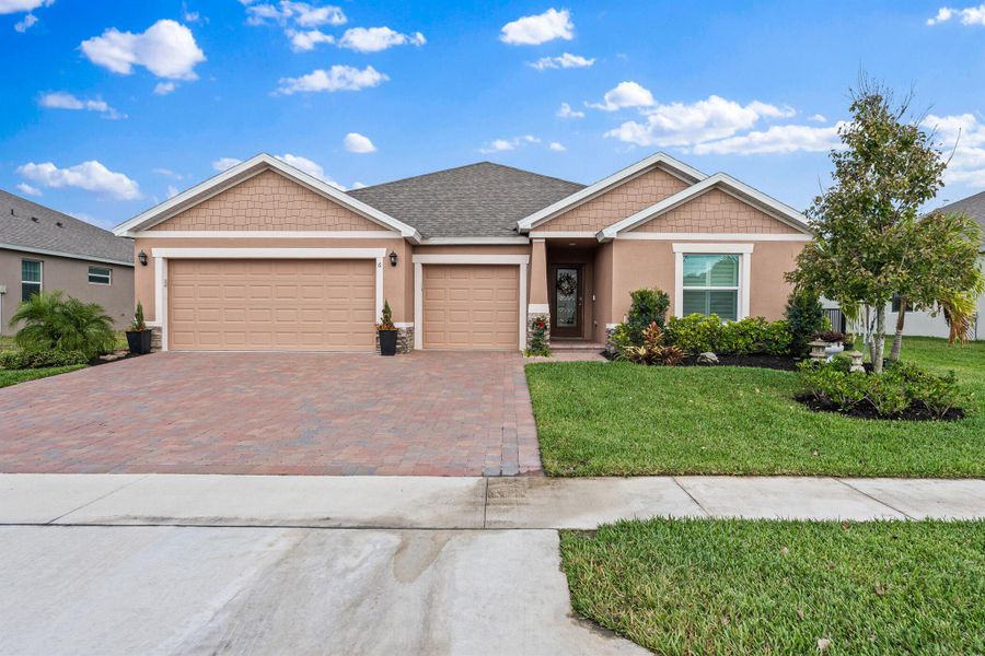 Front exterior of a new home in Grande Hammock, Vero Beach, FL, highlighting curb appeal (Image 22). Front exterior of a new home in Grande Hammock, Vero Beach, FL, highlighting curb appeal (Image 22).