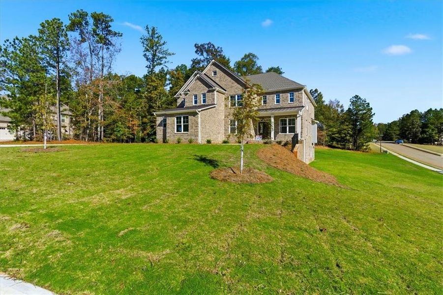 Front exterior of a new home in The Estates at Hurricane Pointe, Douglasville, GA, highlighting curb appeal (Image 1).
