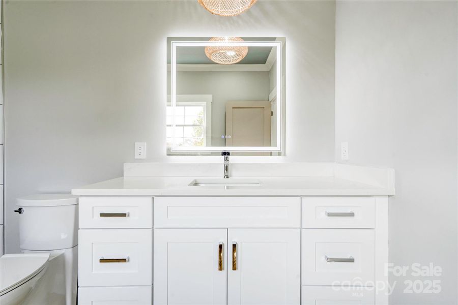 Primary Vanity with Quartz Countertops and defogging mirrors