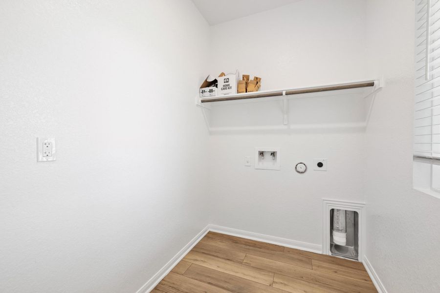 Laundry area with washer hookup, hookup for an electric dryer, wood finished floors, and hookup for a gas dryer Laundry area with washer hookup, hookup for an electric dryer, wood finished floors, and hookup for a gas dryer