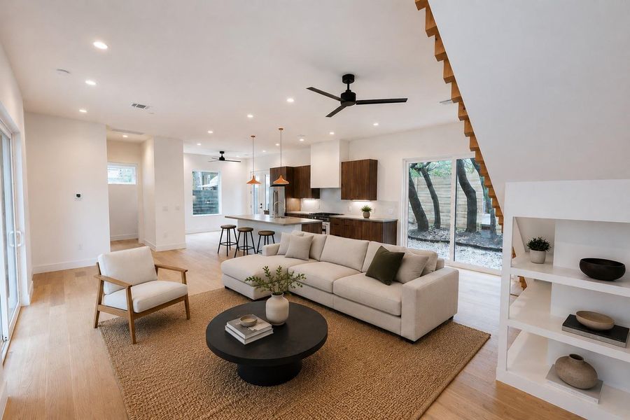 Natural light floods this inviting living space, connecting seamlessly with a modern kitchen and an outdoor patio. (virtually staged) Natural light floods this inviting living space, connecting seamlessly with a modern kitchen and an outdoor patio. (virtually staged)