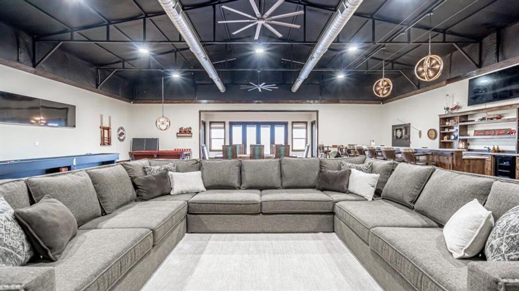 Living room featuring beverage cooler and carpet floors Living room featuring beverage cooler and carpet floors