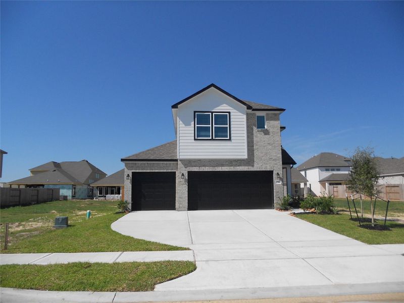 Front exterior of a new home in , Dayton, TX, highlighting curb appeal (Image 1). Front exterior of a new home in , Dayton, TX, highlighting curb appeal (Image 1).