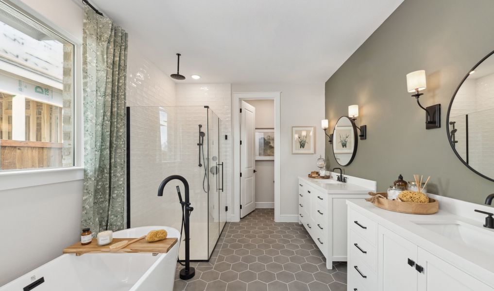 Primary bath with freestanding tub and dual vanities