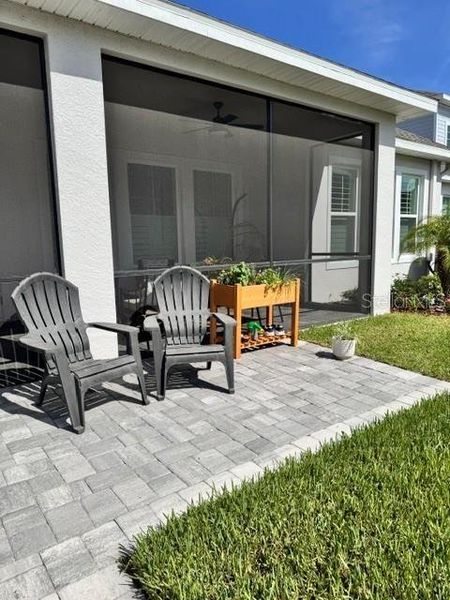 Exterior details and patio area of a home in Emerald Landing at Waterside at Lakewood Ranch – Lake Series, Sarasota (Image 4).