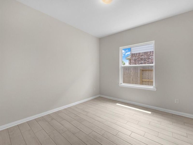 A room with a window and a tile floor. A room with a window and a tile floor.