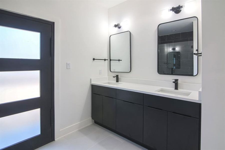 Bathroom featuring vanity, a shower, and tile patterned flooring