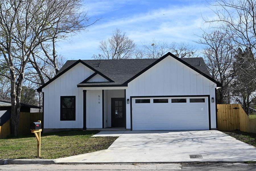 Modern farmhouse style home with concrete driveway, roof with shingles, board and batten siding, a garage, and a porch