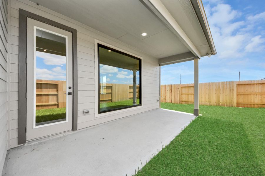 Experience outdoor living at its finest on this expansive covered patio, thoughtfully designed for BBQs and delightful outdoor dining.