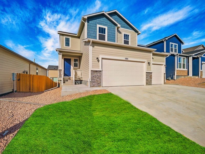 Front exterior of a new home in Ridge at Lorson Ranch, Colorado Springs, CO, highlighting curb appeal (Image 18).