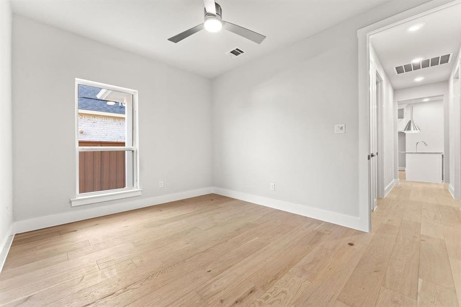 Unfurnished room featuring ceiling fan and light wood-type flooring