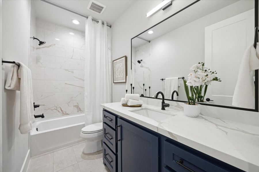 Upstairs hall-access bathroom.