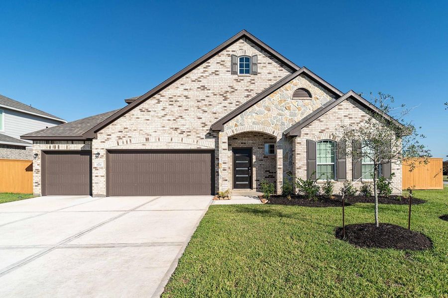 Front exterior of a new home in Sierra Vista, Rosharon, TX, highlighting curb appeal (Image 1). Front exterior of a new home in Sierra Vista, Rosharon, TX, highlighting curb appeal (Image 1).