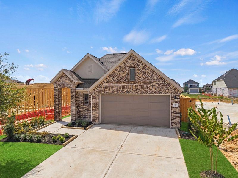 Front exterior of a new home in Candela, Richmond, TX, highlighting curb appeal (Image 21).