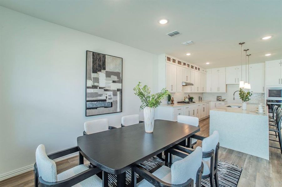 Dining area featuring dark wood-type flooring and recessed lighting Dining area featuring dark wood-type flooring and recessed lighting