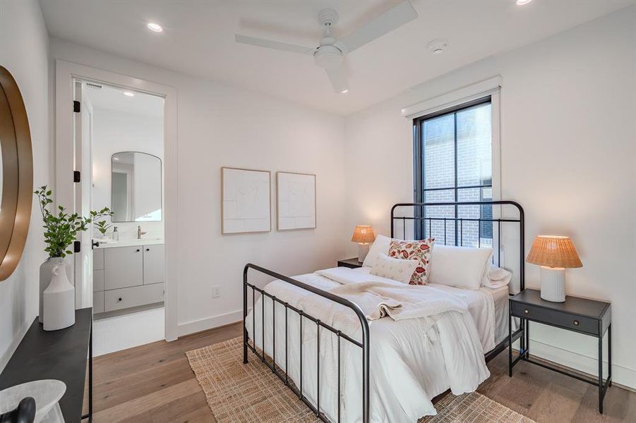 Bedroom with wood finished floors, recessed lighting, ceiling fan, and ensuite bathroom Bedroom with wood finished floors, recessed lighting, ceiling fan, and ensuite bathroom