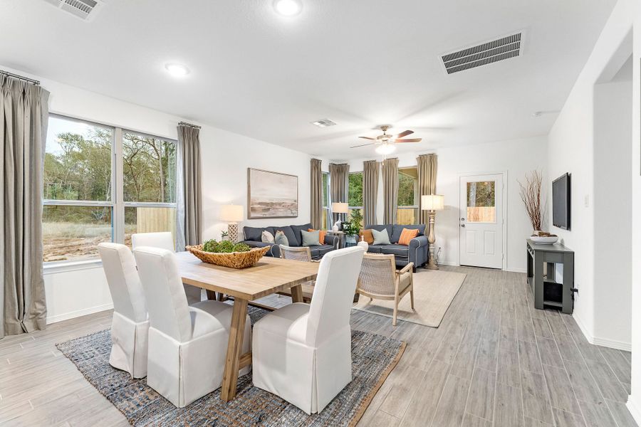 A living room with a dining table and chairs. A living room with a dining table and chairs.