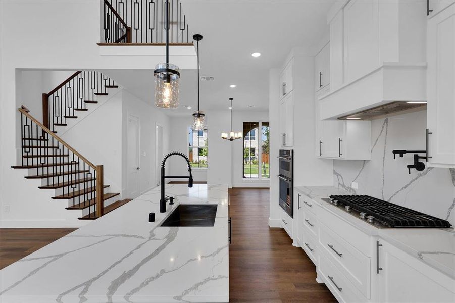 Kitchen with dark wood-style flooring, pendant lighting, stainless steel appliances, recessed lighting, and premium range hood Kitchen with dark wood-style flooring, pendant lighting, stainless steel appliances, recessed lighting, and premium range hood
