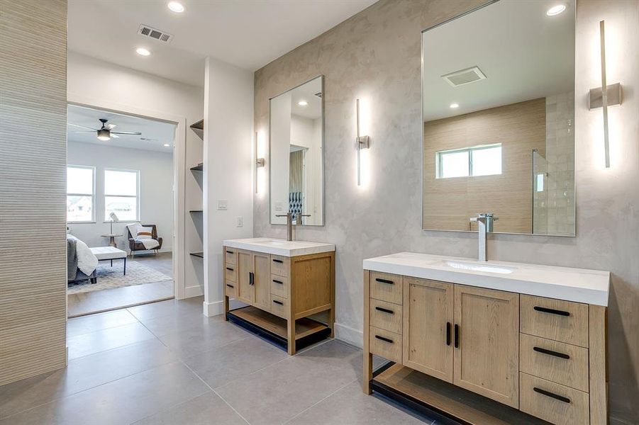 Ensuite bathroom with two vanities, light tile patterned floors, recessed lighting, and a ceiling fan Ensuite bathroom with two vanities, light tile patterned floors, recessed lighting, and a ceiling fan