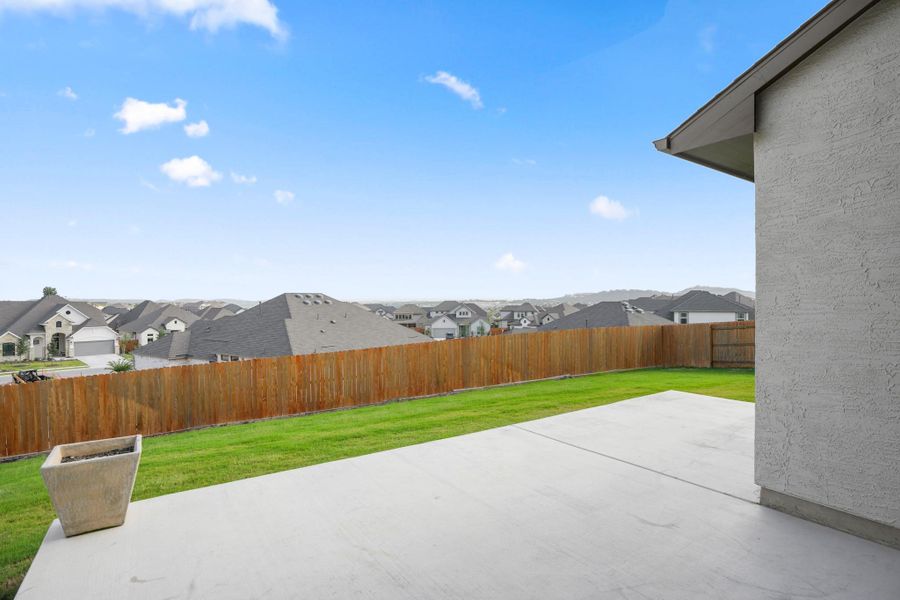 A spacious backyard provides a private green oasis within a thriving neighborhood.