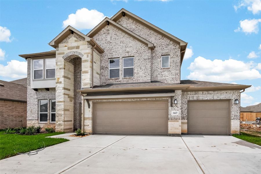 Front exterior of a new home in Foxtail Palms, Manvel, TX, highlighting curb appeal (Image 23). Front exterior of a new home in Foxtail Palms, Manvel, TX, highlighting curb appeal (Image 23).