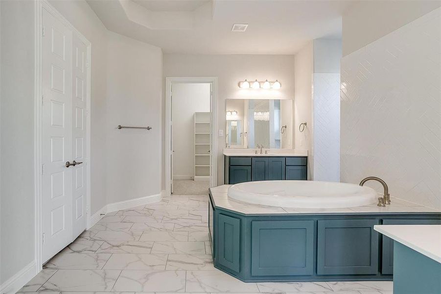 Bathroom featuring a bathing tub and vanity