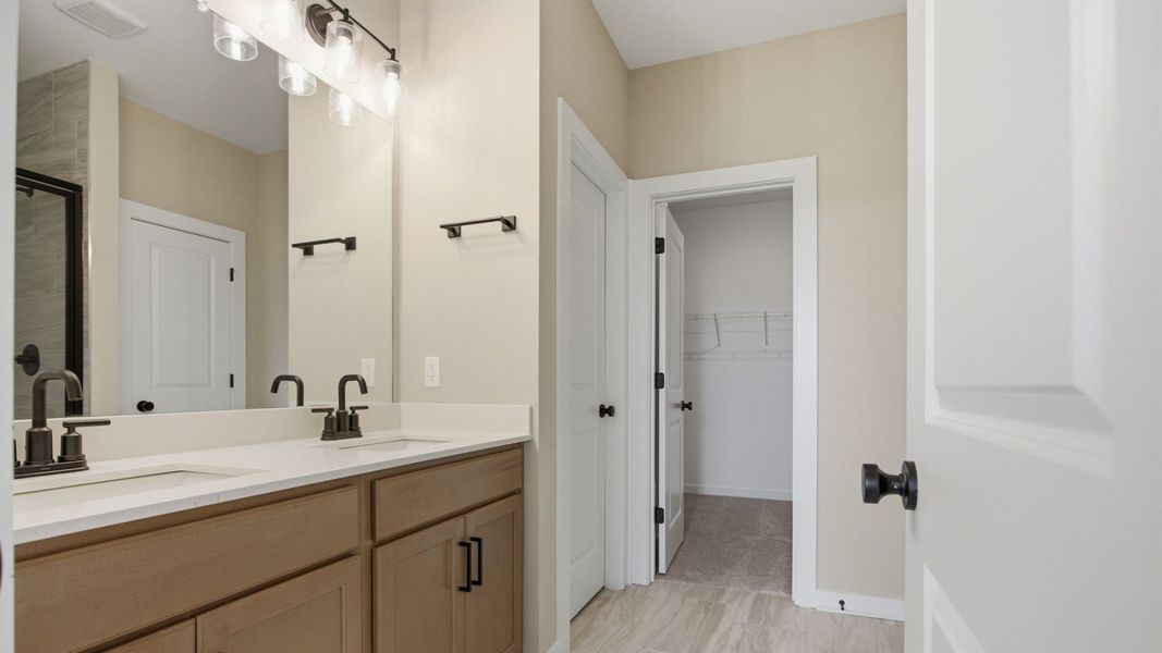 Bathroom with dual vanity and access to closet Bathroom with dual vanity and access to closet